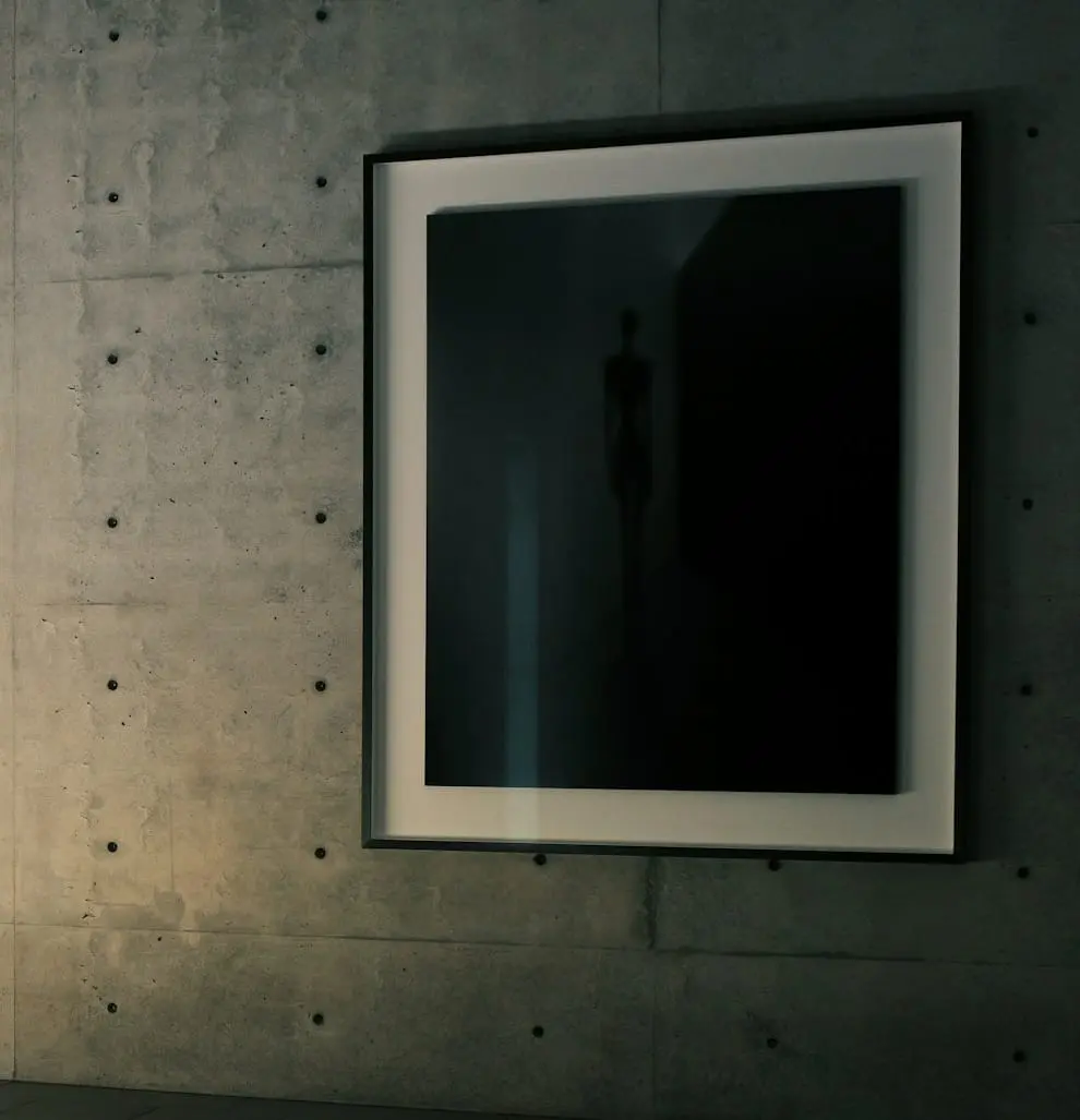 Detail of a framed artwork on a concrete wall