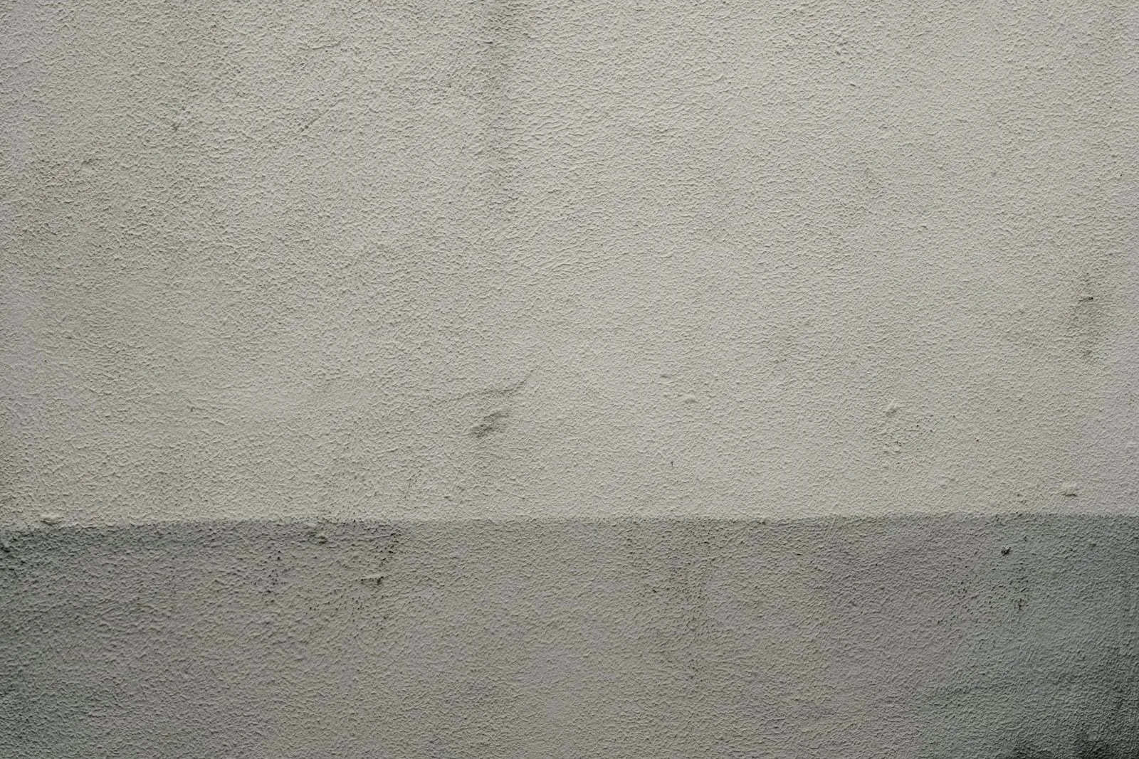 Close view of pale plaster with a shadow line