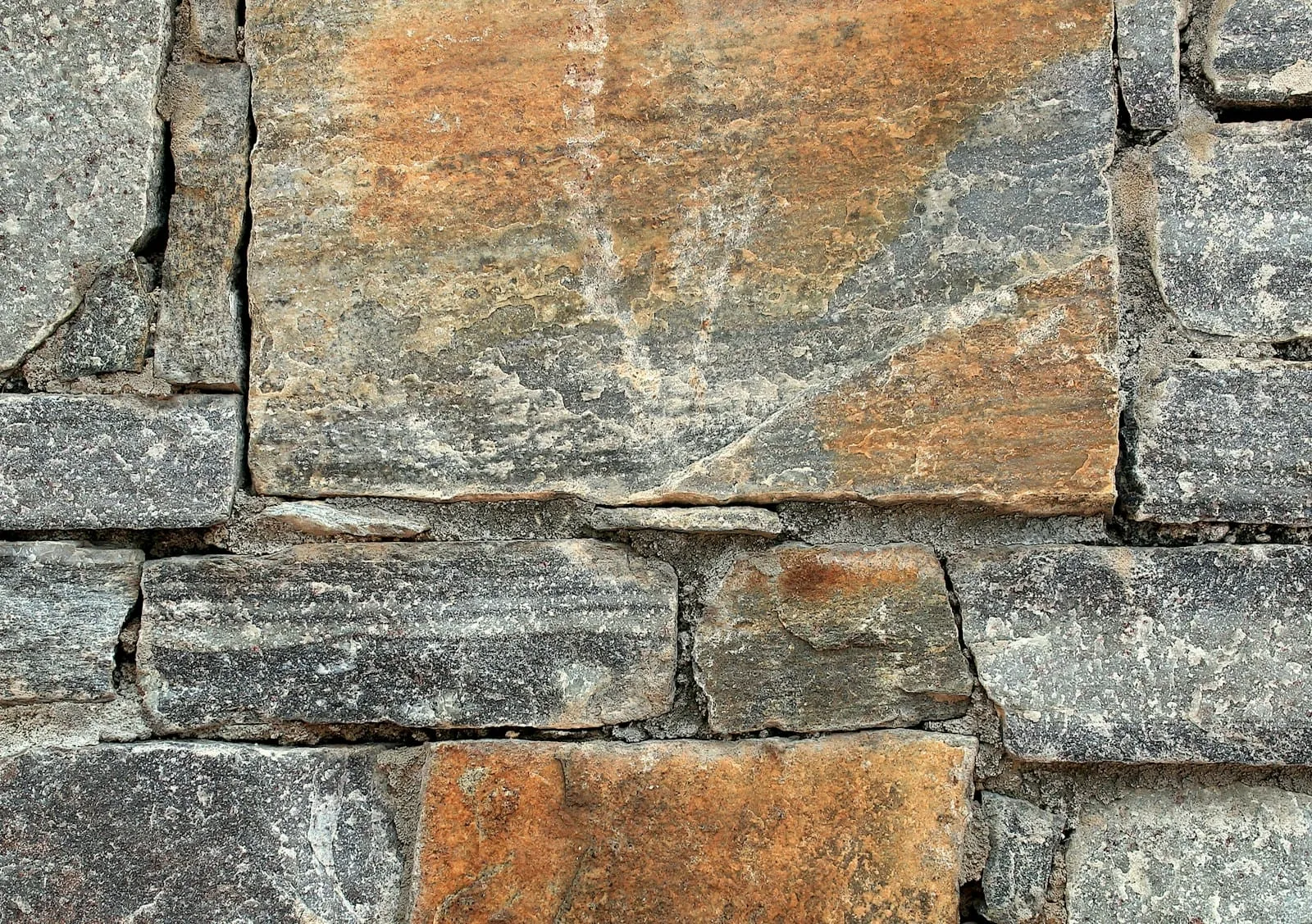 Layered slate wall with iron-stained faces