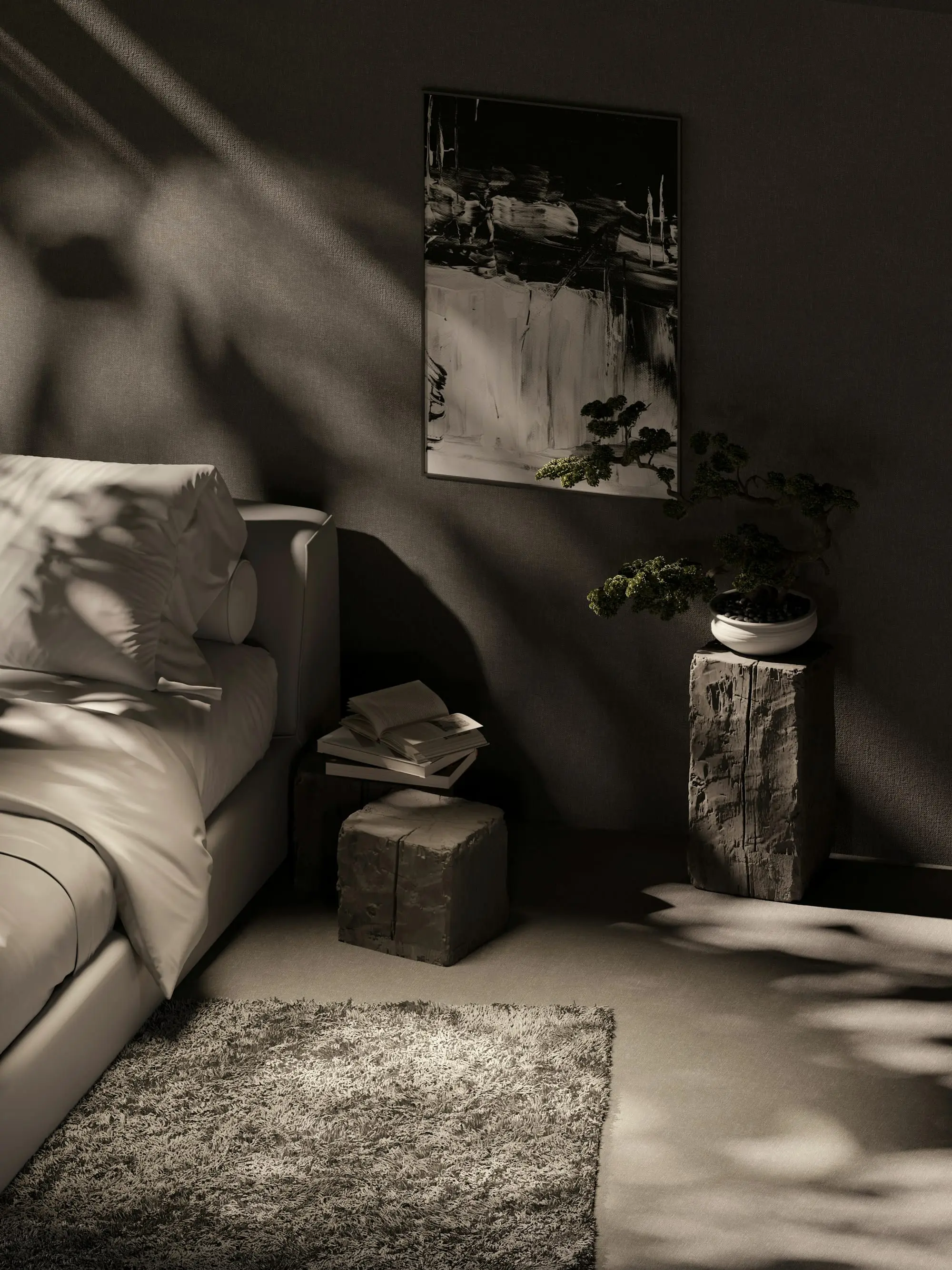 Corner of a room with a low sofa, a stone side table and a framed work in raking light