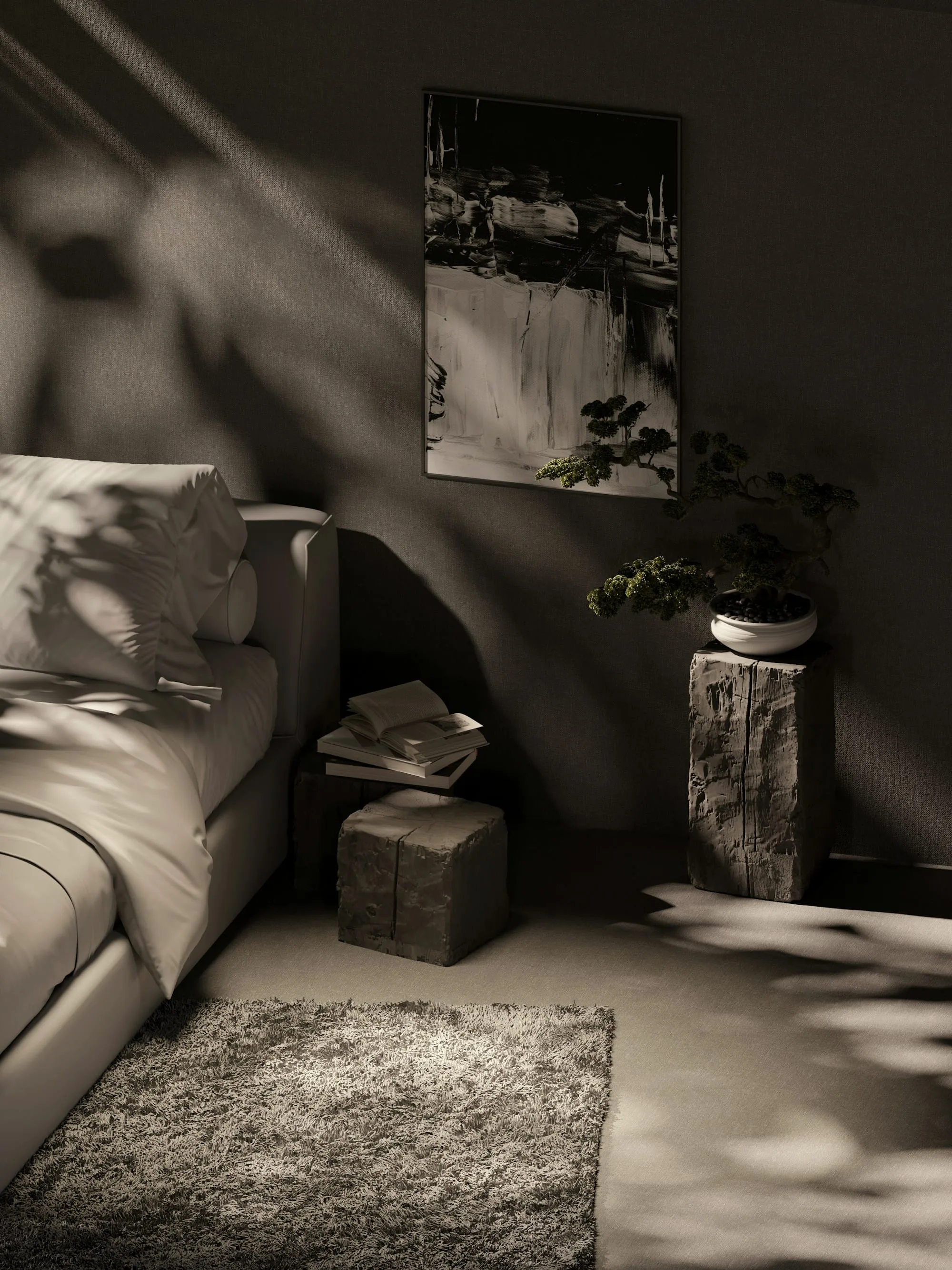 Corner of a room with a low sofa, a stone side table and a framed work in raking light